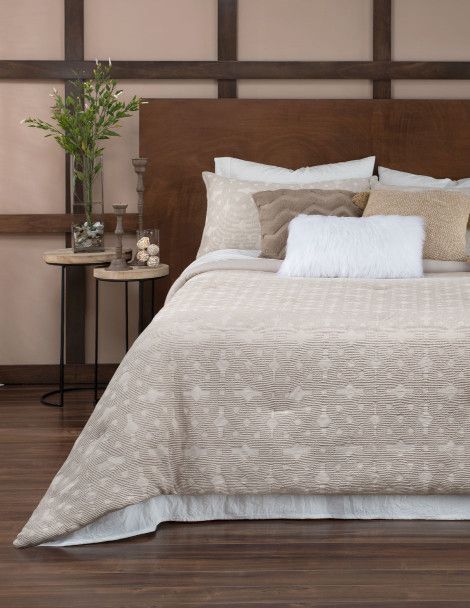 Contemporary bedroom featuring luxurious Gala Quilt with tan jacquard fabric.