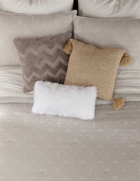 Aerial view of luxurious quilt set highlighting exquisite, champagne colored jacquard fabric.