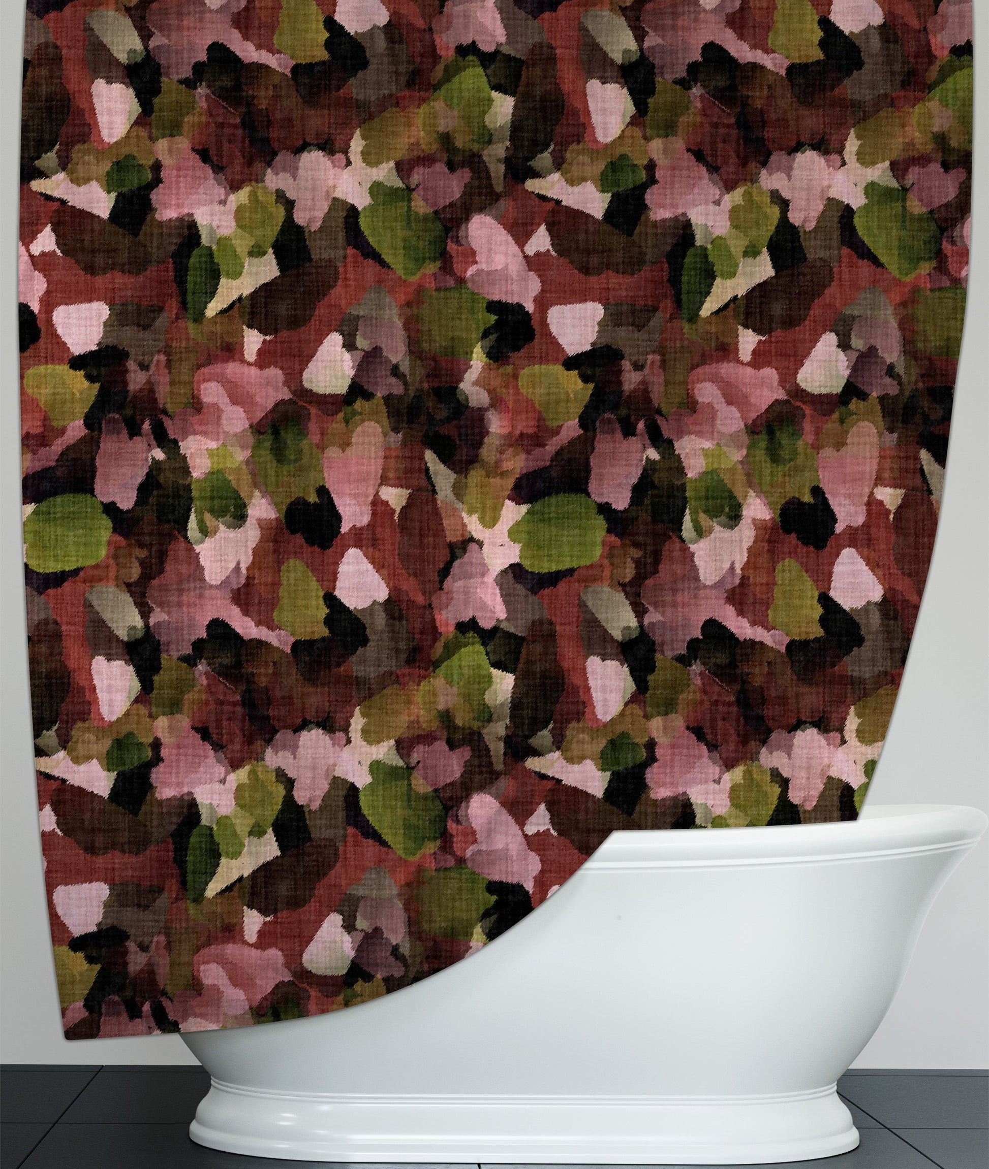 Printed shower curtain, with warm fall leaves design, hanging over freestanding bathtub.