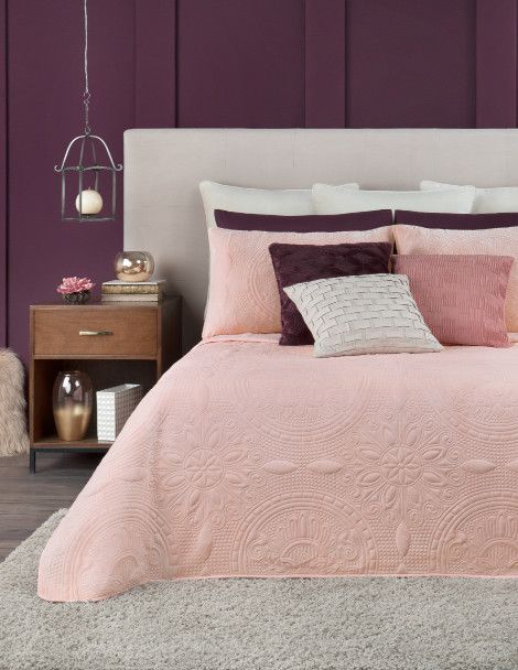 Traditional bedroom featuring pink luxurious quilt with 3D ornamental embroidery and velvet finish.