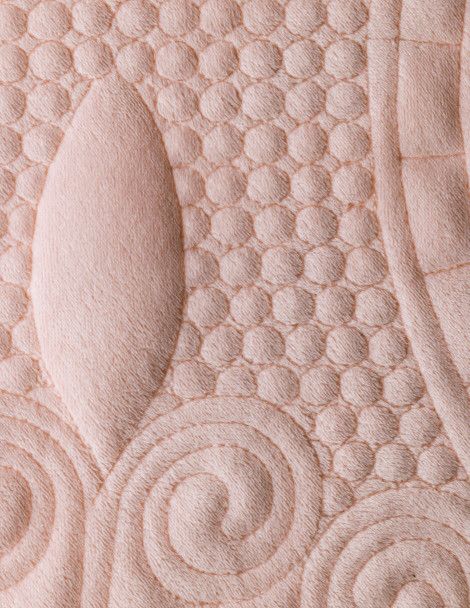 Detail of pink Anastasia Luxus Quilt with detailed embroidery and classic style.