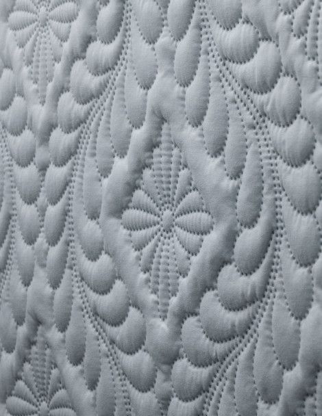 Close up view of gray side of Victoria 3D Quilt with embroidered diamond floral design.