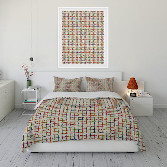 Bright bedroom featuring comforter set with multicolored grid pattern throughout.