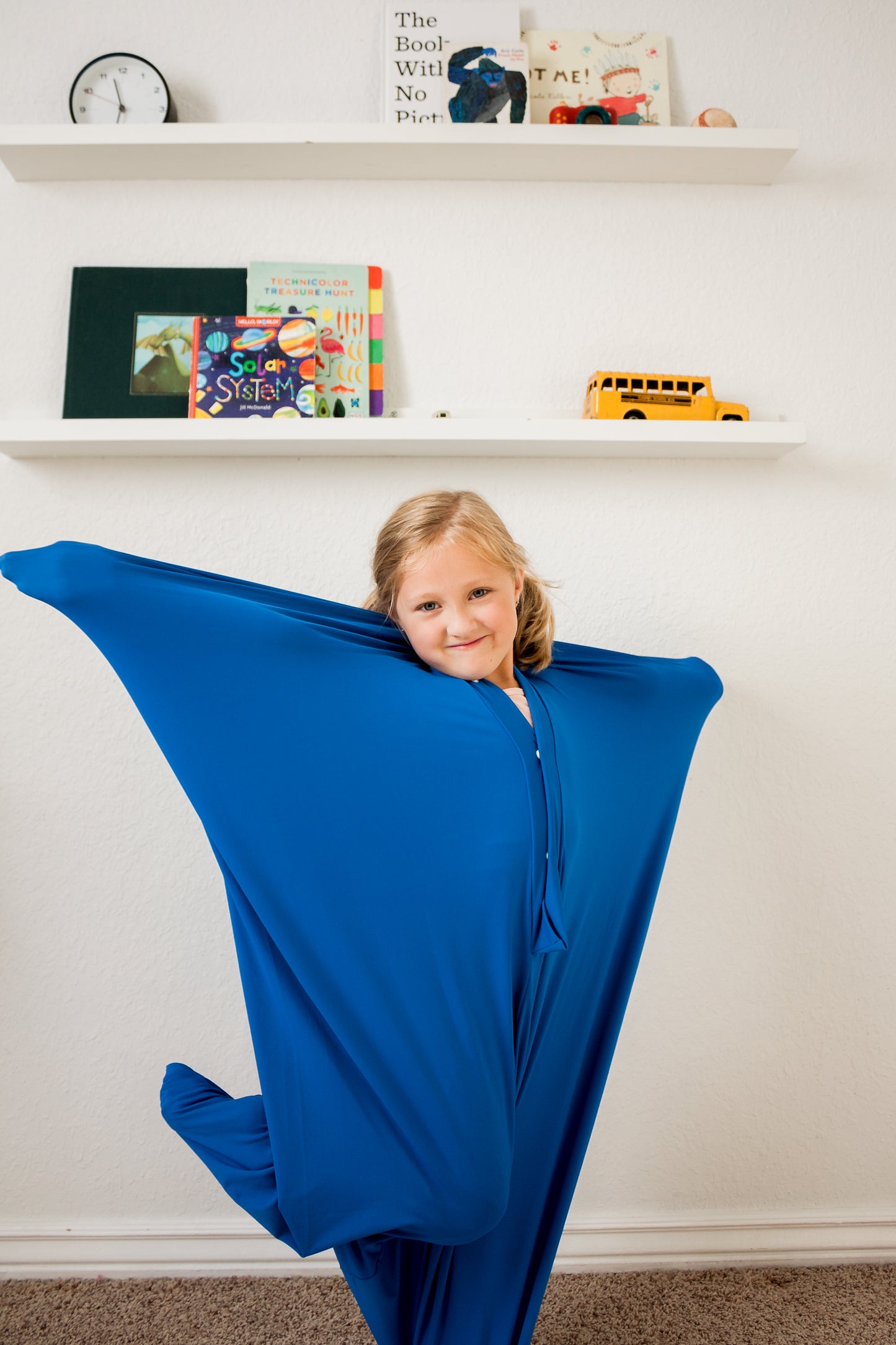 Young girl posing in blue Sensory Body Sock.