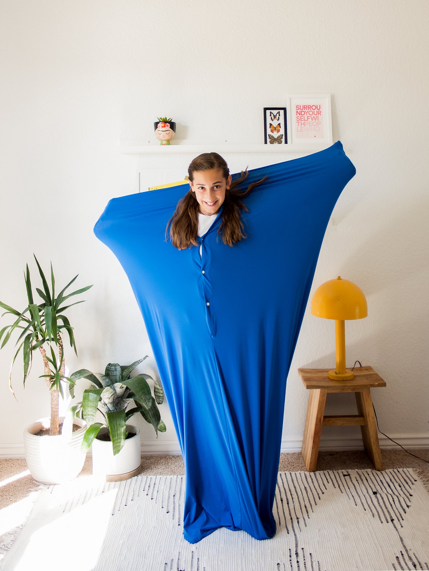 Teen standing in blue stretchy body sock.