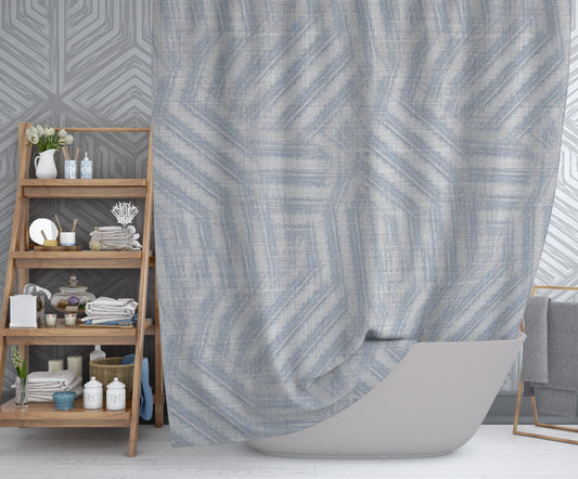 Modern bathroom with hanging printed shower curtain with gray background and blue swirling design throughout.