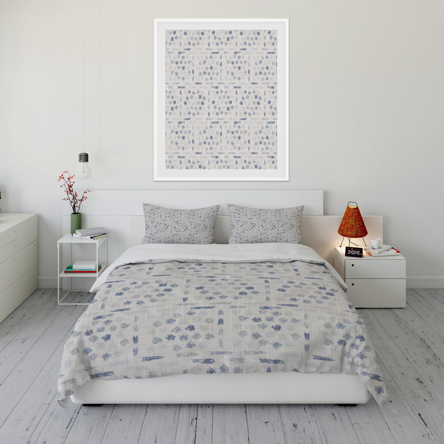 Tidy bedroom displaying inviting comforter set with decorative blue and gray smudges throughout.