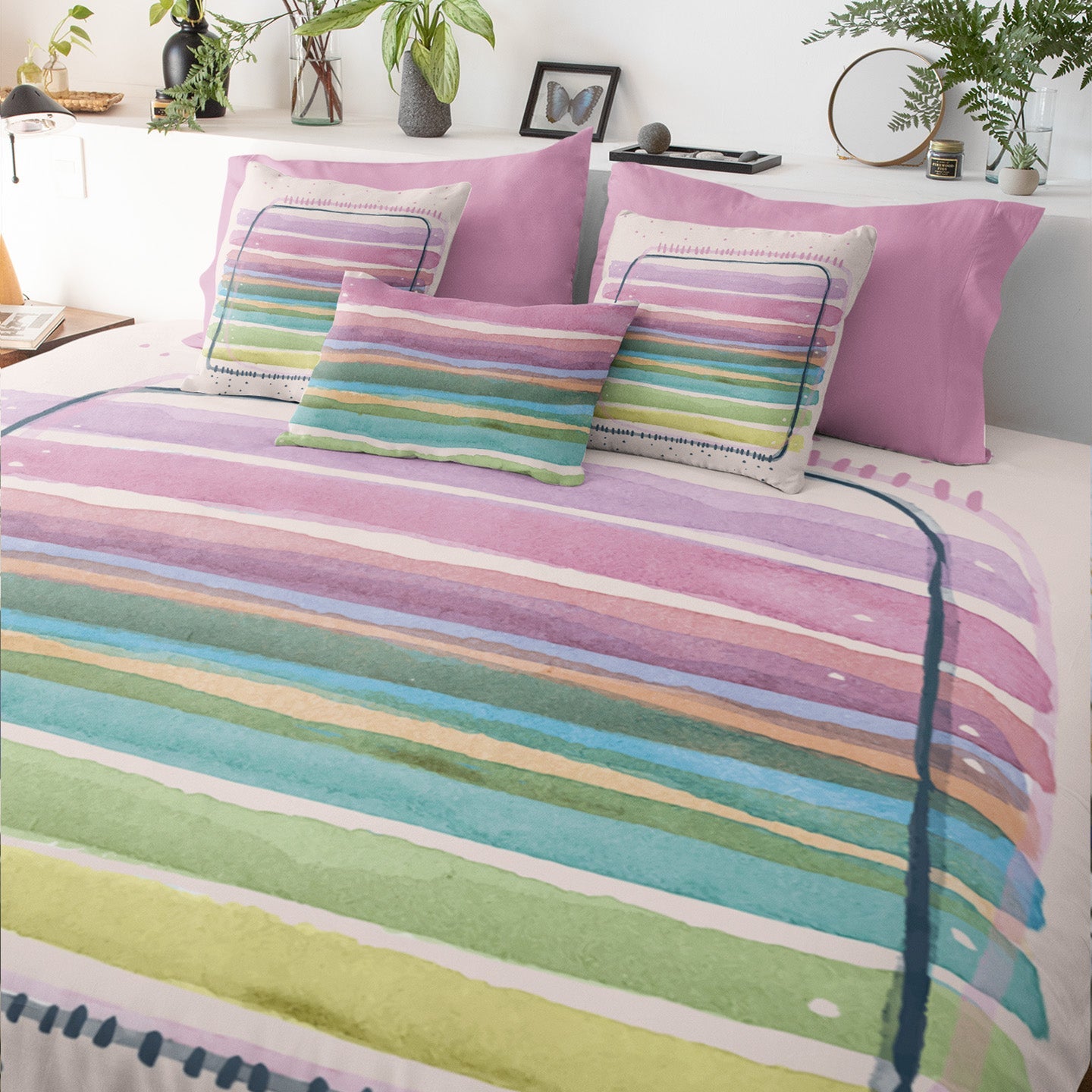 Fresh bedroom featuring printed comforter with pastel brushstroke design.