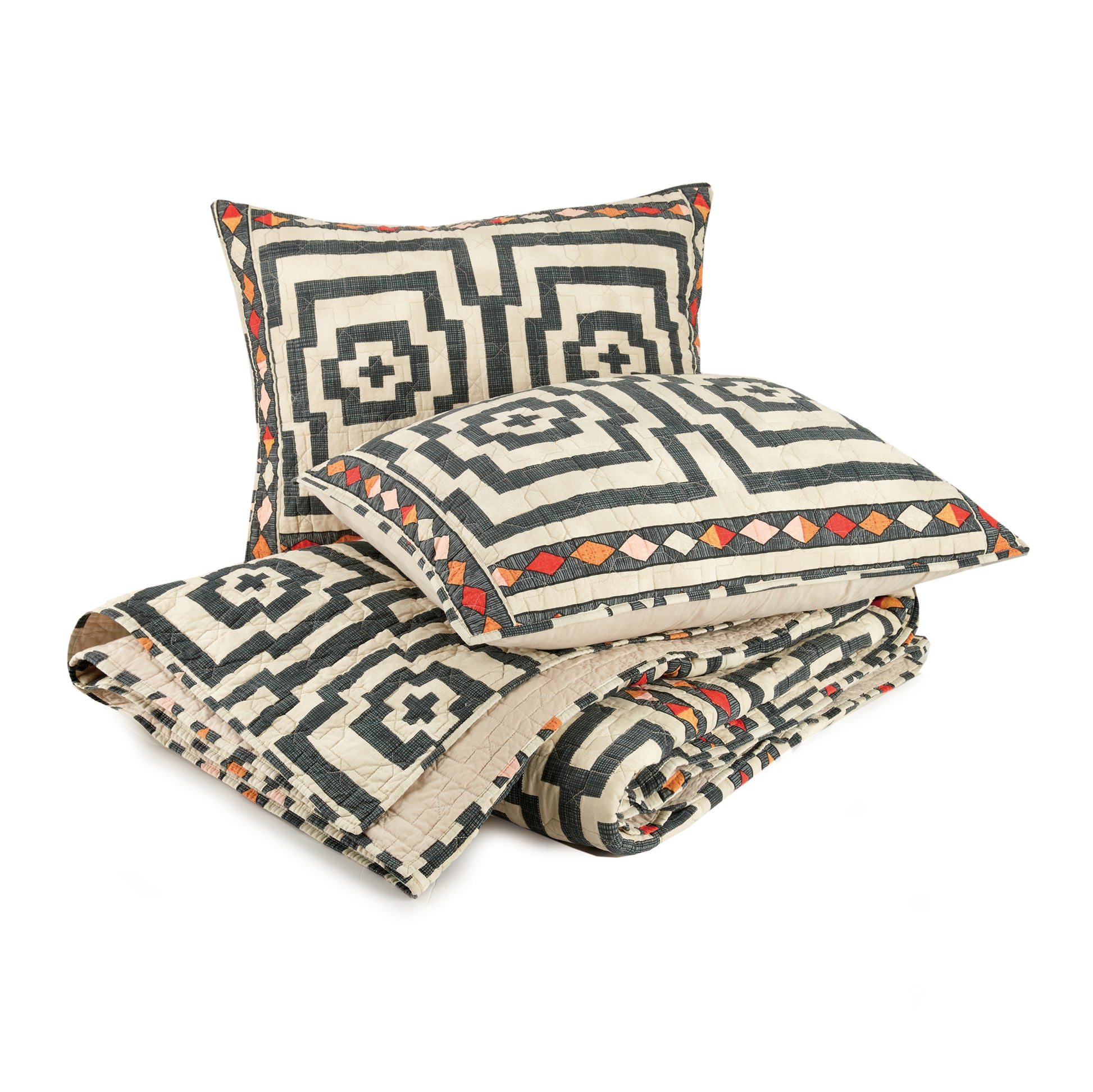 Two pillows atop a matching black and ivory Hypnotic quilt by Justina Blakeney