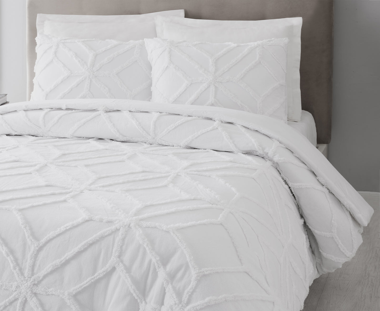 Close up of bed featuring white Trina Turk Trellis Duvet Set.