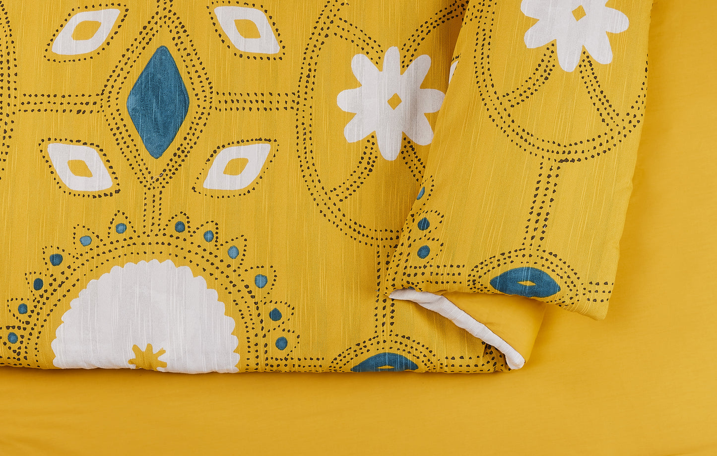 Detail view of Lemieux Et Cie Duvet Cover with mustard and white pattern.