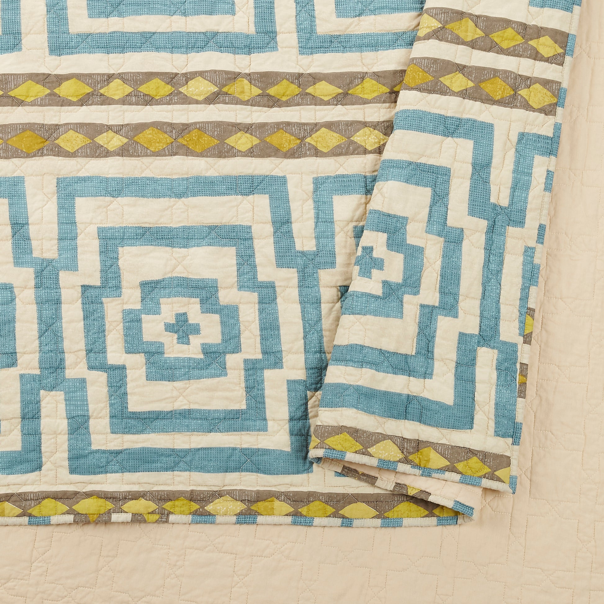 Close up of blue and ivory Hypnotic quilt with Greek key design by Justina Blakeney