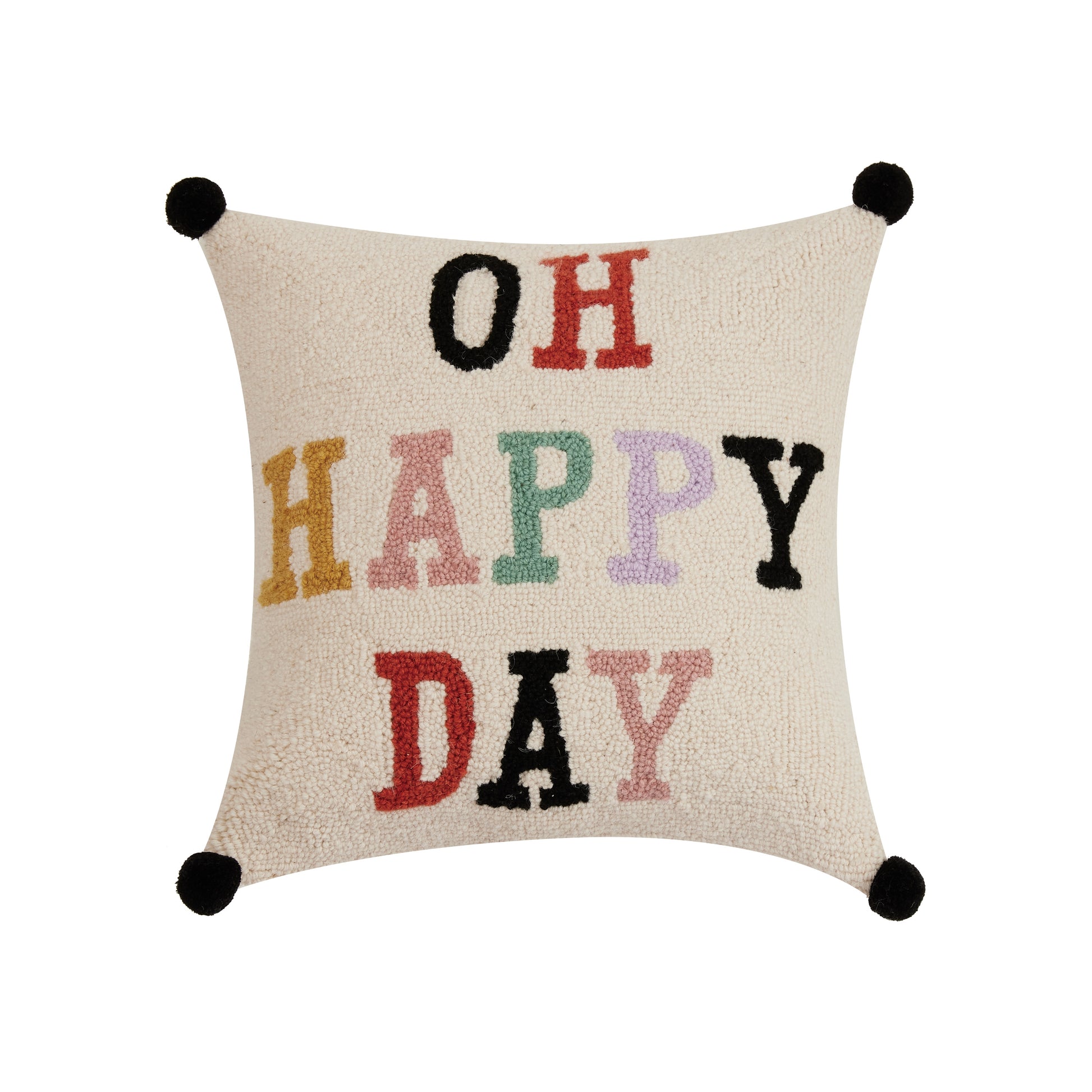 Cream Yvonne Ellen throw pillow with black tassels and multi-colored letters that read, “Oh Happy Day.”