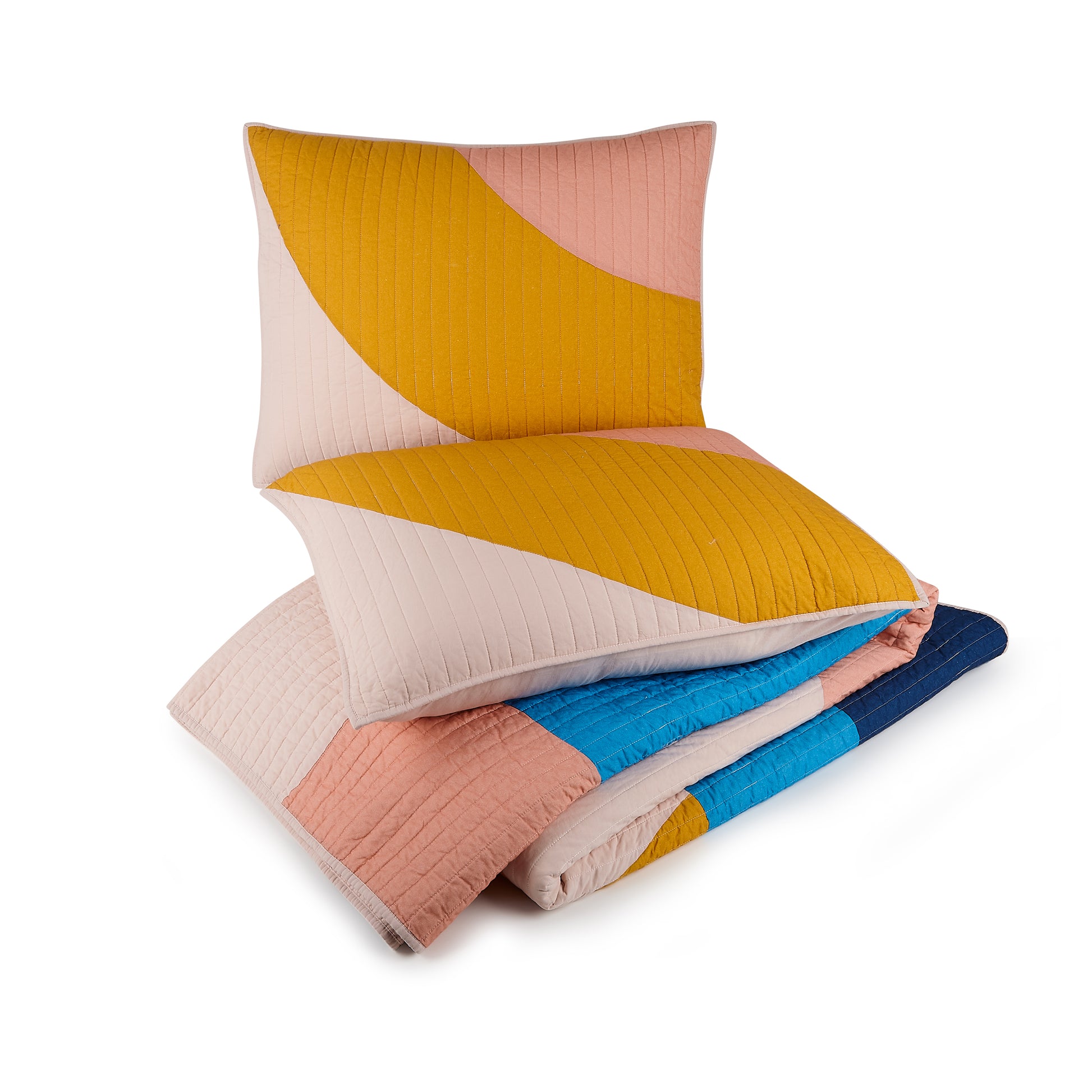 Two pillows atop matching quilt with colorful, connecting shapes in yellow, blue and pink.