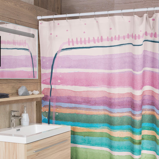 Modern bathroom with printed shower curtain featuring pastel watercolor design.